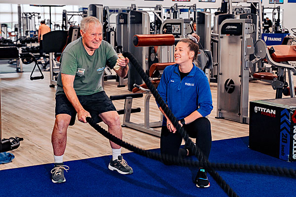 Senior man doing a workout with a personal trainer at West Conshy Athletic Center.